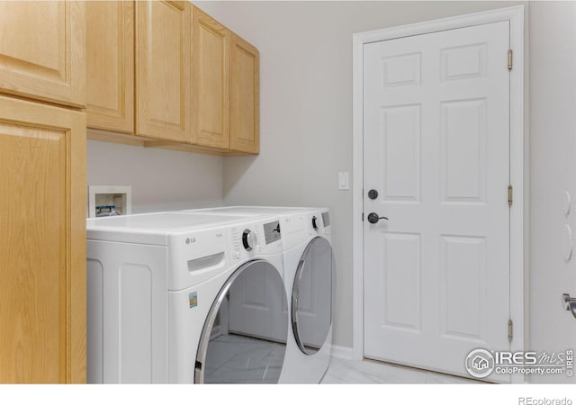 laundry room with cabinets and washing machine and dryer