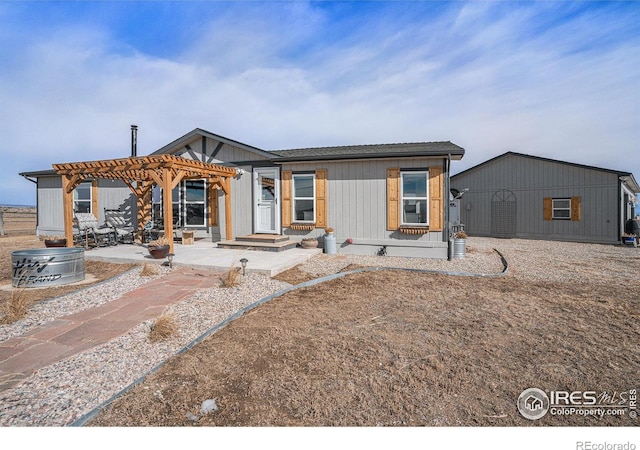 view of front of house featuring a pergola and a patio area