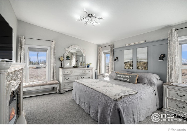 carpeted bedroom featuring lofted ceiling