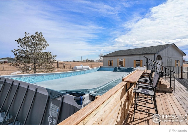 view of swimming pool featuring a hot tub and a wooden deck