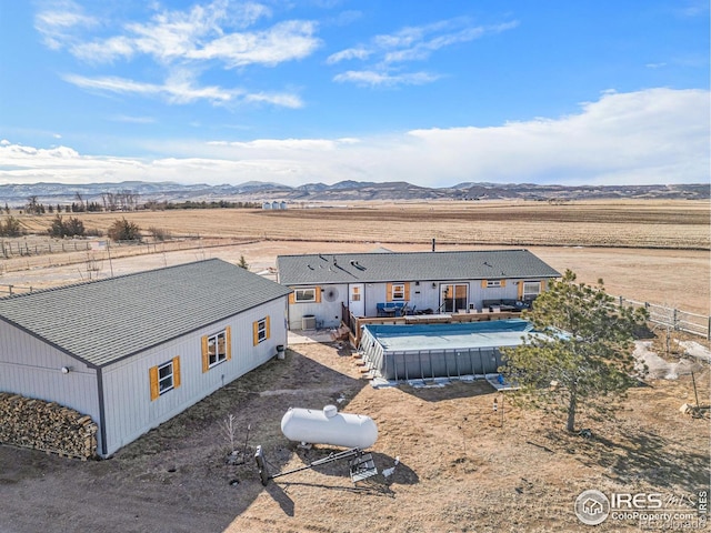 drone / aerial view featuring a mountain view and a rural view