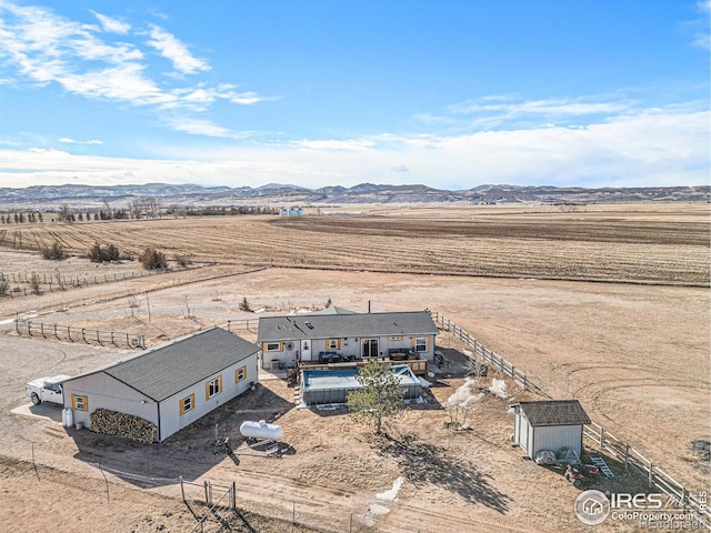 birds eye view of property featuring a mountain view and a rural view