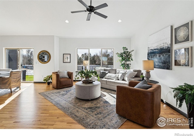 living room with ceiling fan and light hardwood / wood-style floors