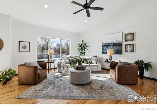 living room featuring ceiling fan, lofted ceiling, and hardwood / wood-style floors