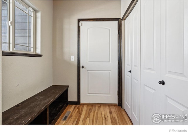 hallway with light hardwood / wood-style flooring