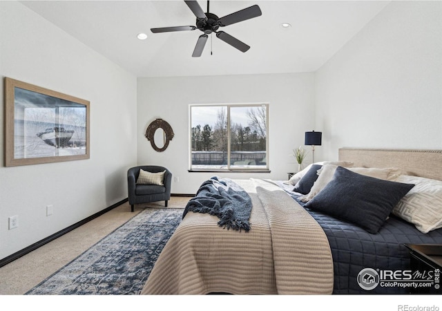 carpeted bedroom with vaulted ceiling and ceiling fan