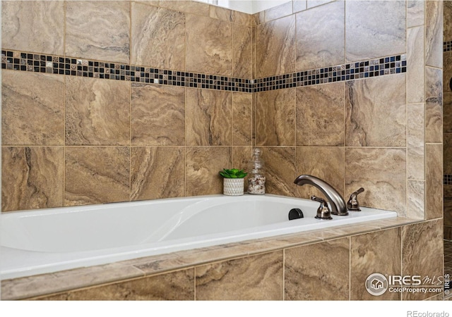 bathroom featuring tiled bath