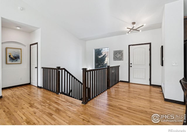 foyer entrance featuring a chandelier and light wood-type flooring