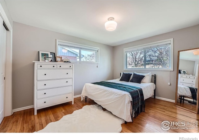 bedroom with a closet and light hardwood / wood-style flooring