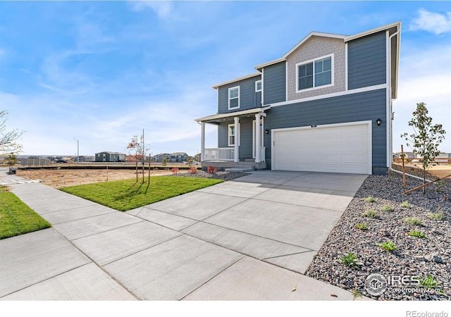 view of front of home featuring a garage, a front lawn, and covered porch