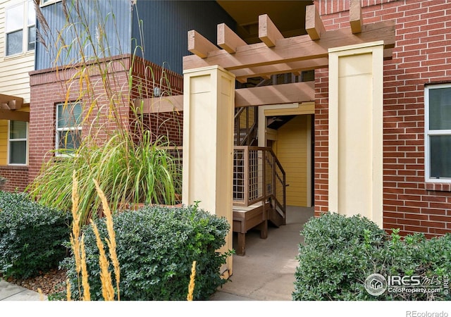 doorway to property featuring a pergola