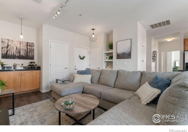 living room with dark hardwood / wood-style flooring