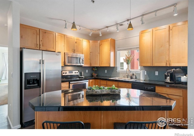 kitchen featuring sink, hanging light fixtures, stainless steel appliances, a kitchen breakfast bar, and light brown cabinetry