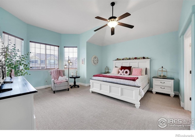 carpeted bedroom with ceiling fan and vaulted ceiling