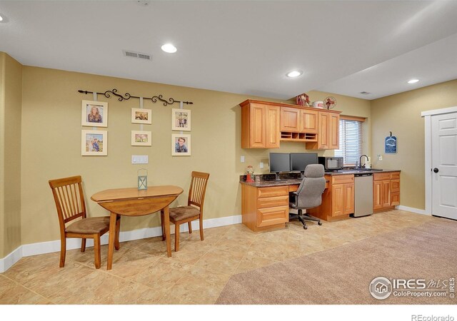 home office featuring sink and built in desk