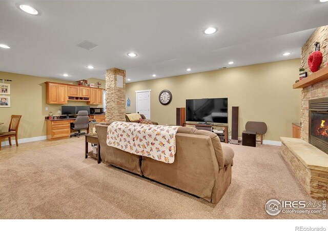 living room featuring a fireplace and light colored carpet