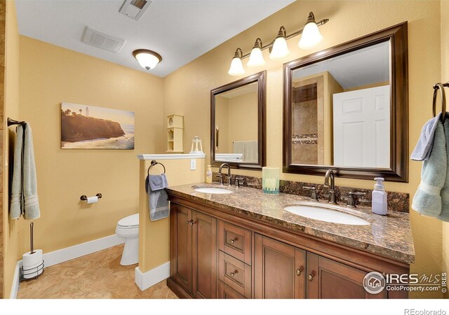 bathroom with vanity, toilet, and tile patterned flooring