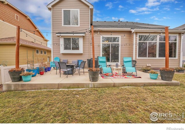 back of house with a yard and a patio area