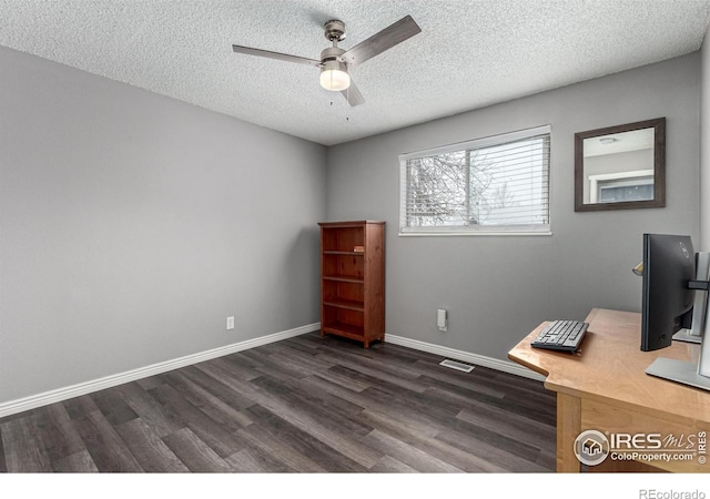 unfurnished office with dark wood-type flooring, ceiling fan, and a textured ceiling