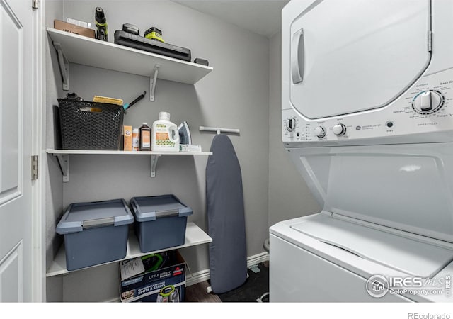 clothes washing area featuring stacked washer and dryer