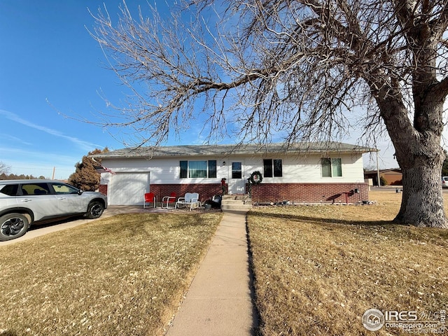 single story home featuring a garage and a front lawn