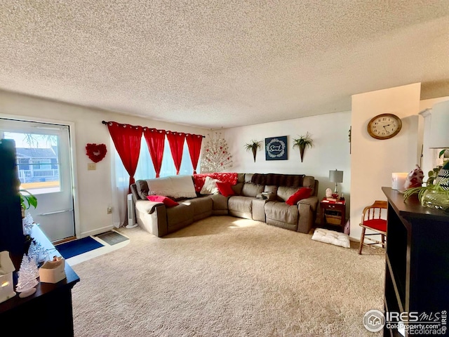 carpeted living room featuring a textured ceiling