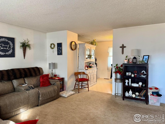 carpeted living room featuring a textured ceiling