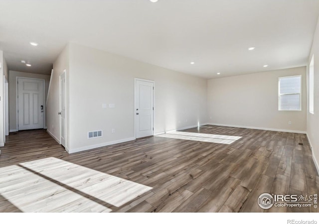 spare room featuring wood-type flooring