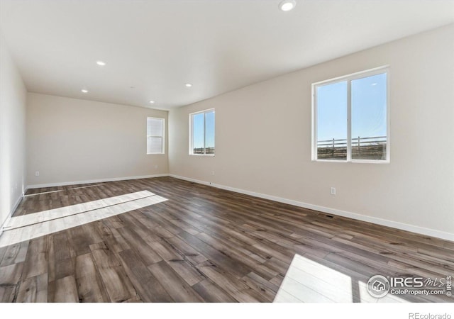 unfurnished room featuring dark hardwood / wood-style flooring