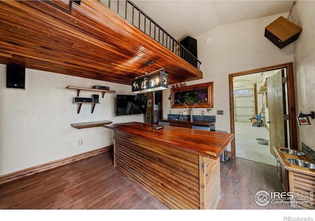 kitchen with dark wood-type flooring and lofted ceiling