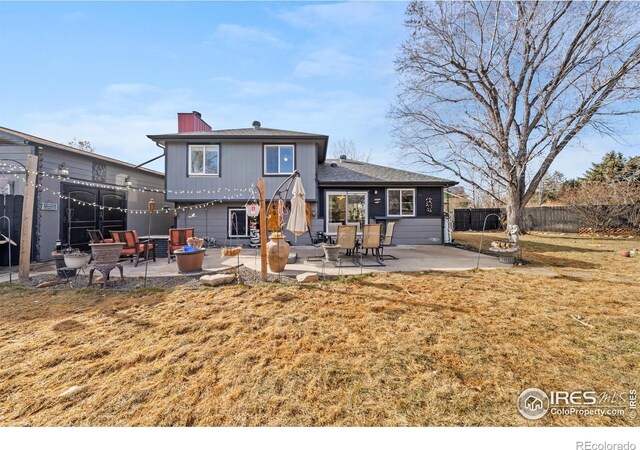 back of house with a yard and a patio area