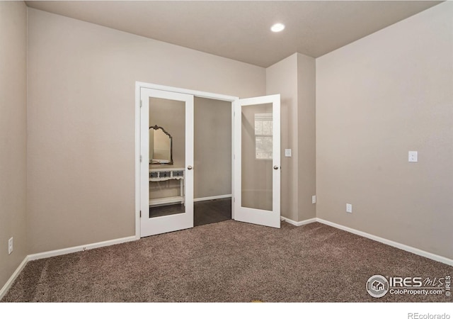 unfurnished bedroom with carpet and french doors