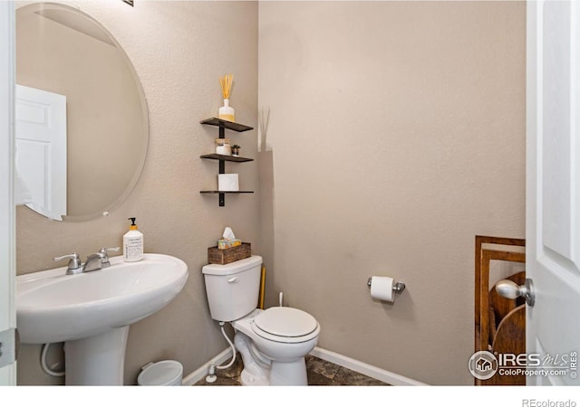 bathroom featuring toilet and sink