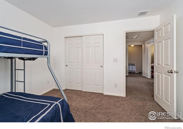 bedroom featuring dark carpet and a closet