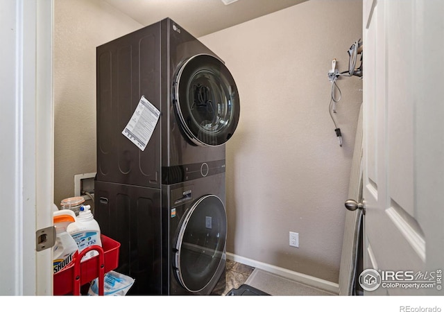 laundry area with stacked washing maching and dryer