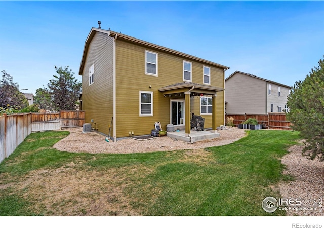 back of house featuring central AC, a patio, and a lawn