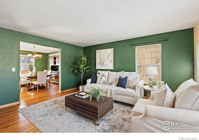 living room featuring hardwood / wood-style flooring and a chandelier