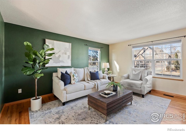 living room with hardwood / wood-style floors and a textured ceiling