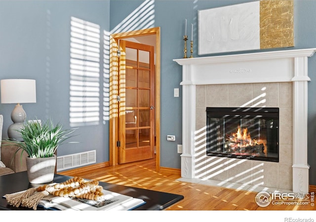 living room featuring hardwood / wood-style flooring and a fireplace