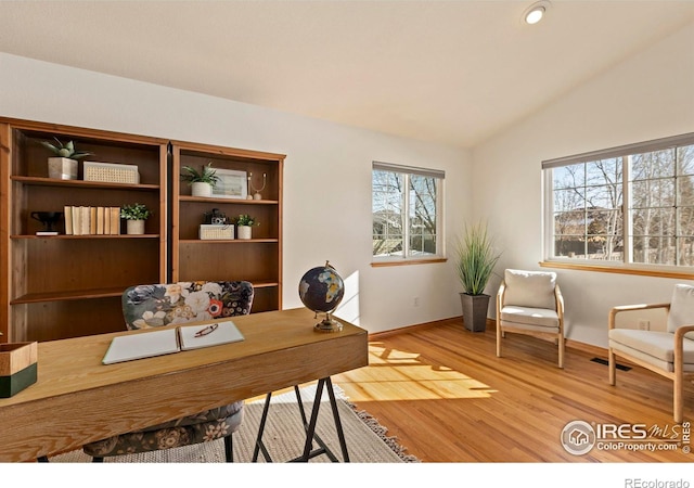 office area featuring vaulted ceiling and wood-type flooring