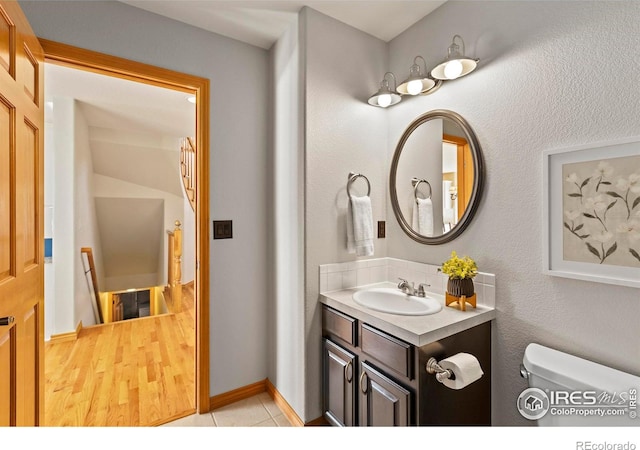 bathroom featuring tile patterned floors, toilet, and vanity