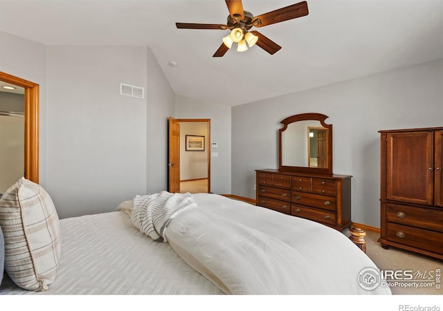 bedroom featuring vaulted ceiling, light colored carpet, and ceiling fan