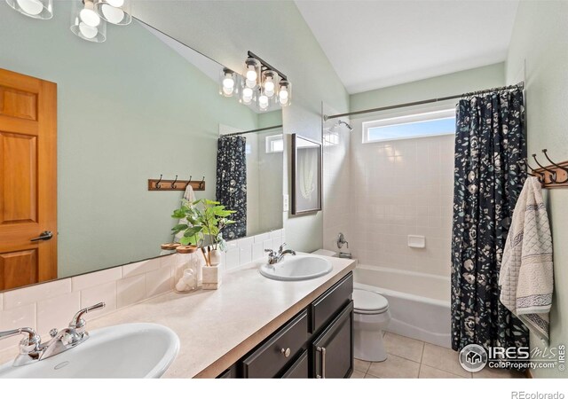 full bathroom featuring toilet, tile patterned floors, shower / bathtub combination with curtain, and vanity