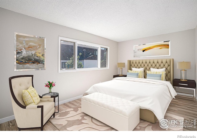 bedroom with hardwood / wood-style flooring and a textured ceiling