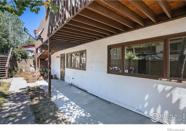 view of side of home with a patio area