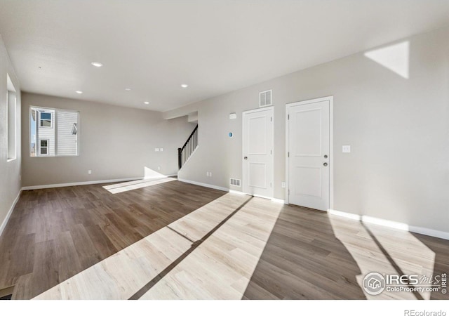 spare room featuring wood-type flooring