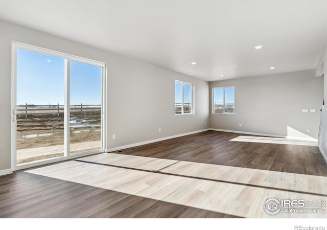 spare room with wood-type flooring