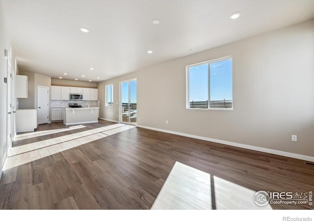 unfurnished living room with wood-type flooring