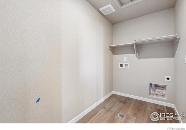 laundry room with hookup for an electric dryer, hookup for a washing machine, and light wood-type flooring