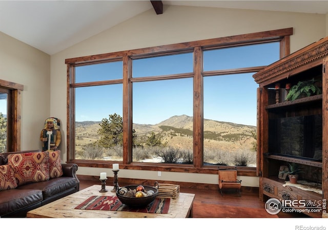 living room with a mountain view, dark wood-type flooring, and vaulted ceiling